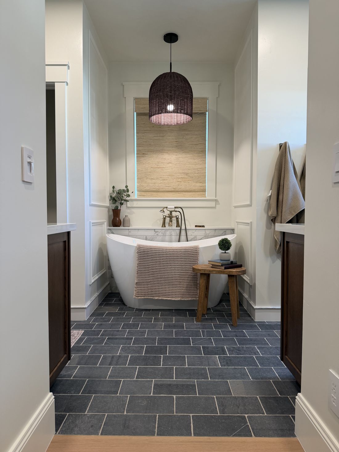 Freestanding tub with custom tile and wood ceiling detail by Big Rig Construction
