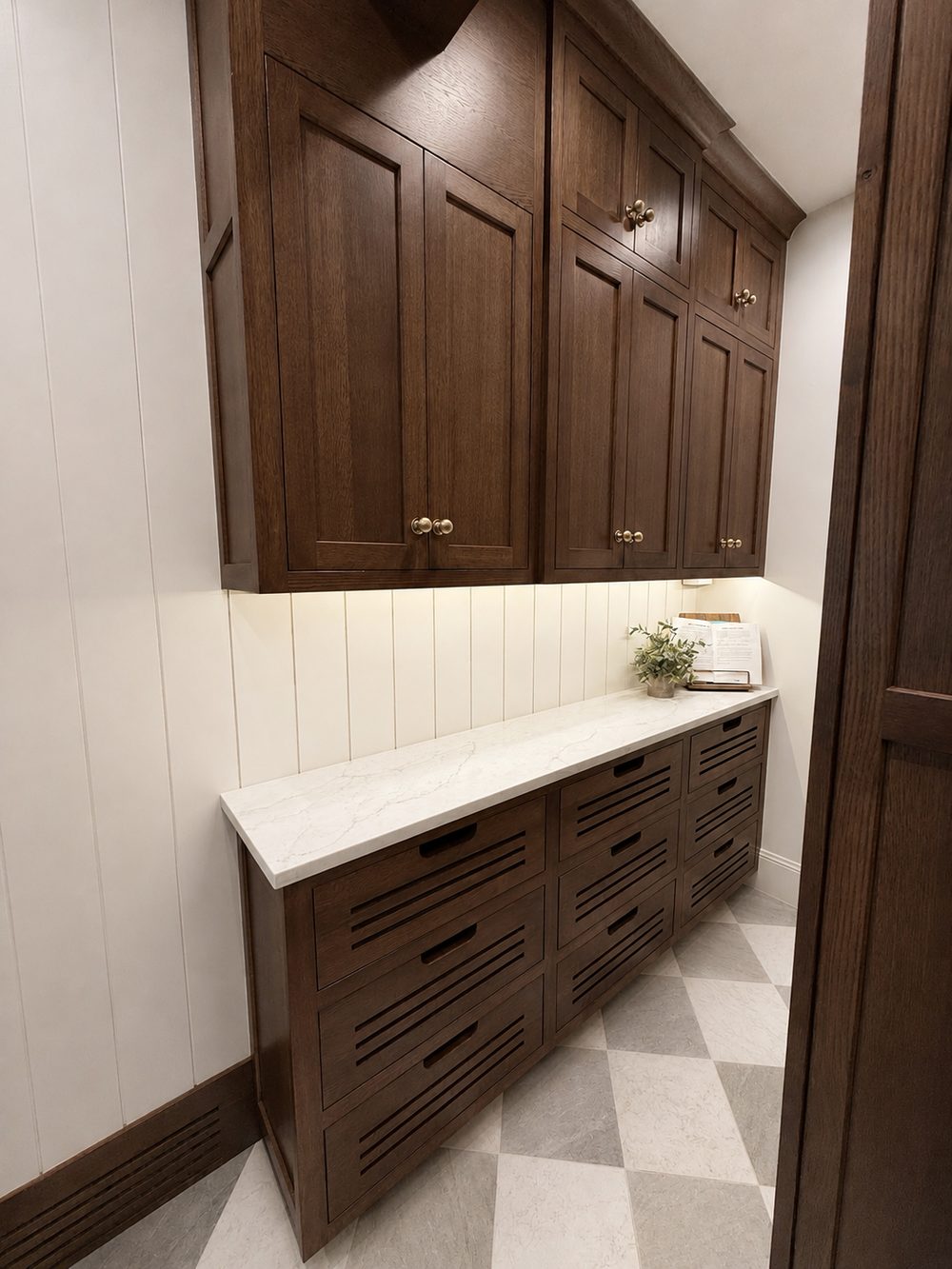 Custom built-in cabinetry installation with brass hardware by Big Rig Construction